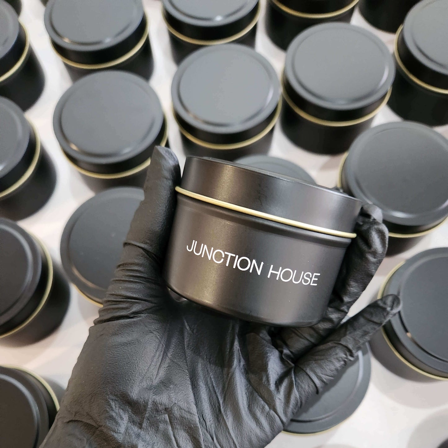 Branded 4oz matte black tin candle for corporate events and promotional giveaways.