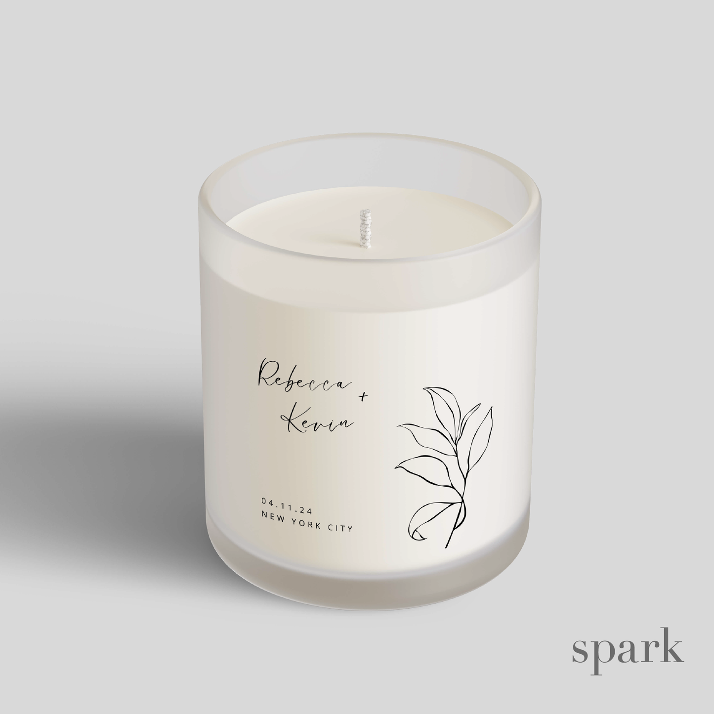 Custom branded frosted clear glass candle produced by a candle manufacturer for client gifts and events.