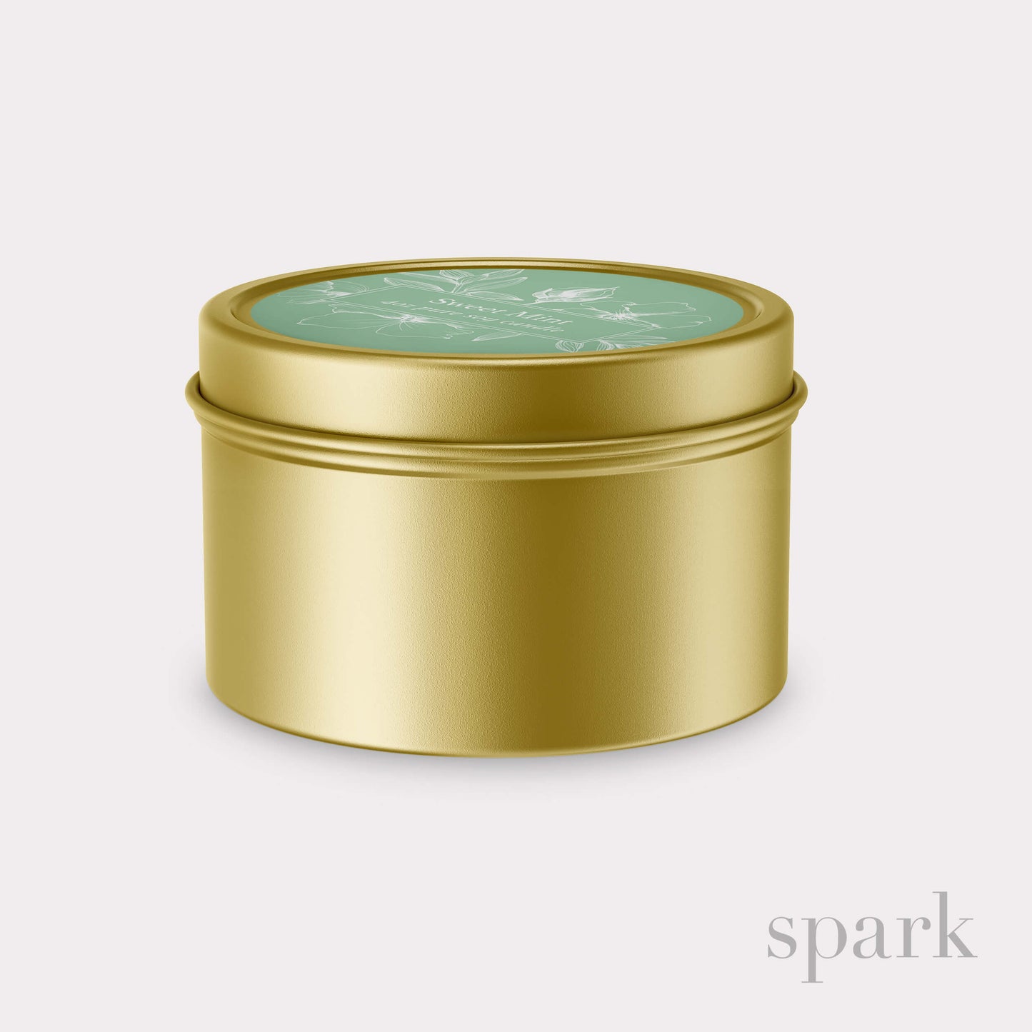 Gold cylindrical tin with a green lid on a light gray background