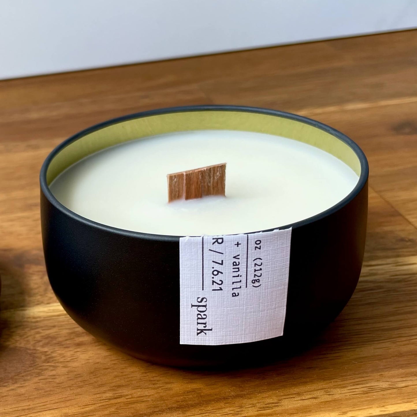 Spark Candles branded 8oz matte black tin candle featuring a full-color custom label and real wood wick